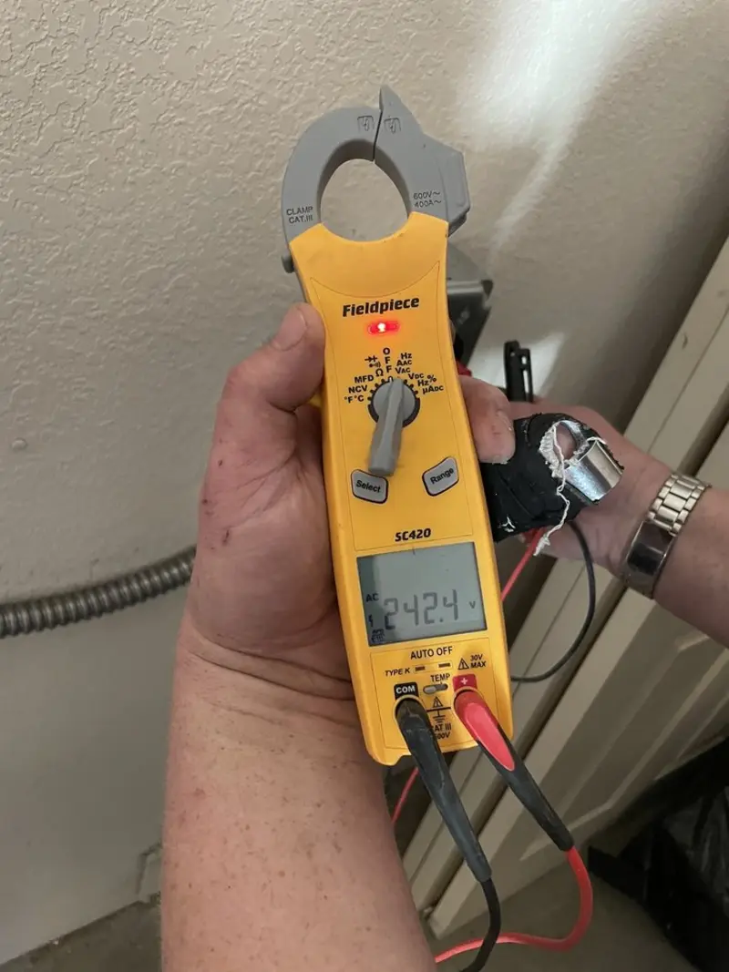 Voltage testing with clamp meter during Recessed Lighting Installation in Temecula